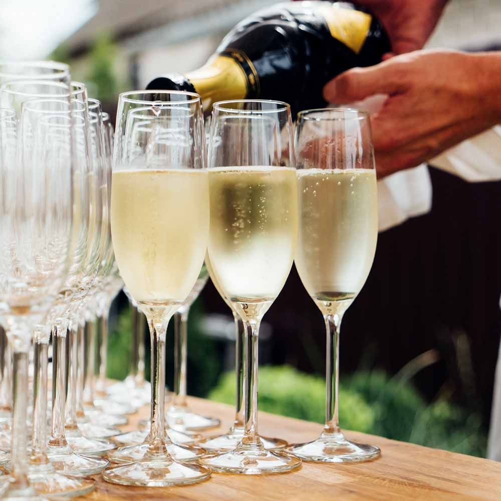 caterer pouring champagne