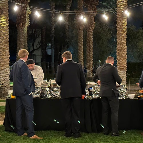Dinner guests at a buffet style catering setup