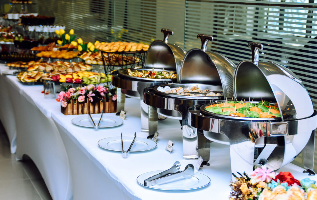 Event catering, buffet table with various foods in heat trays