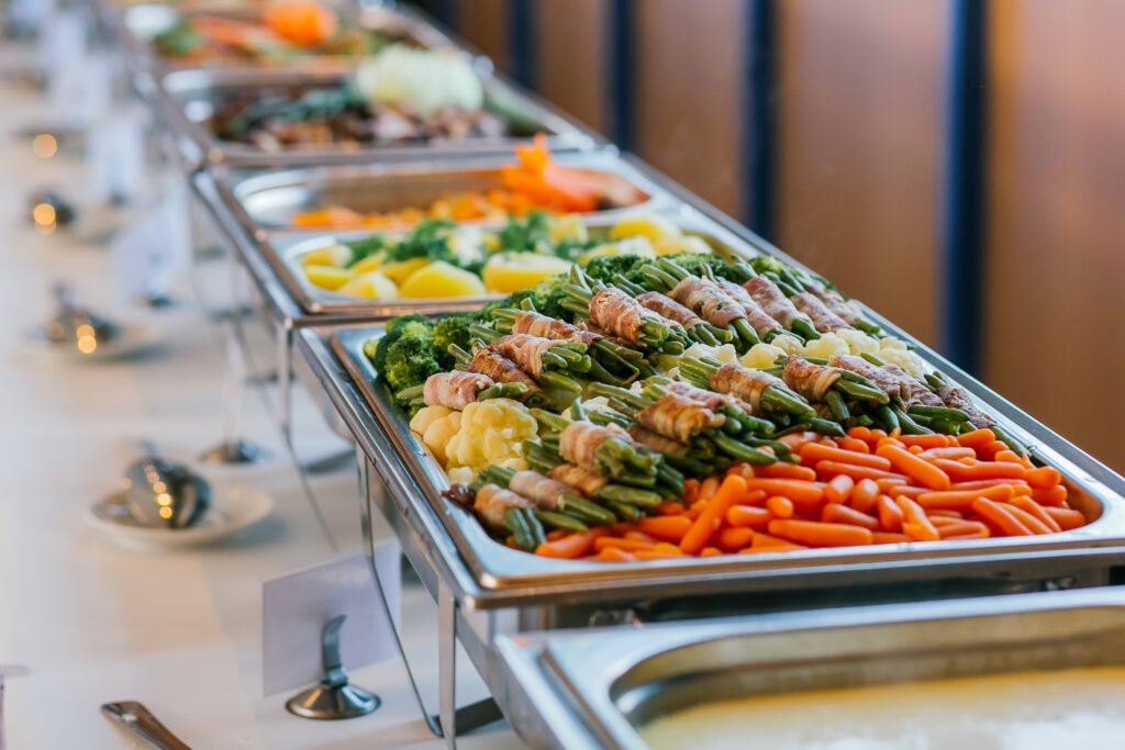 Event buffet table with trays of various foods
